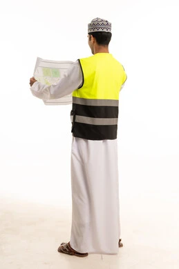 Omani Engineer Holding Construction Plan Back View