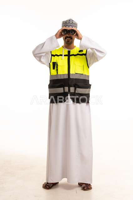 Omani Man in Safety Vest Using Binoculars