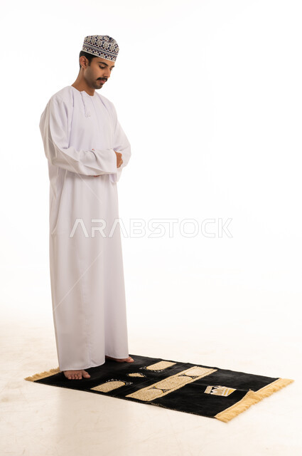 Omani Man Performing Salat on Prayer Rug