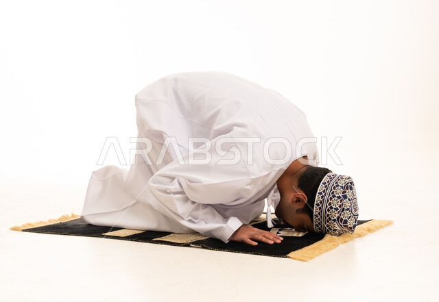 Omani Man Performing Sujud Prayer on Rug