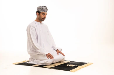 Omani Man Praying on Mat White Background