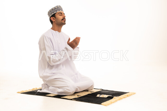 Omani Man Praying on Rug with White Background