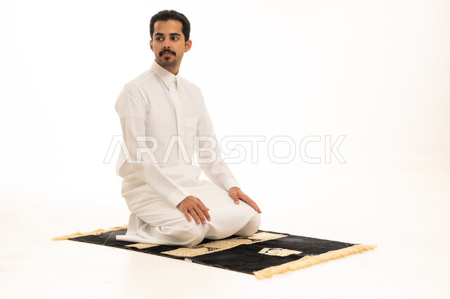 Saudi Man in White Thobe on Prayer Rug Studio