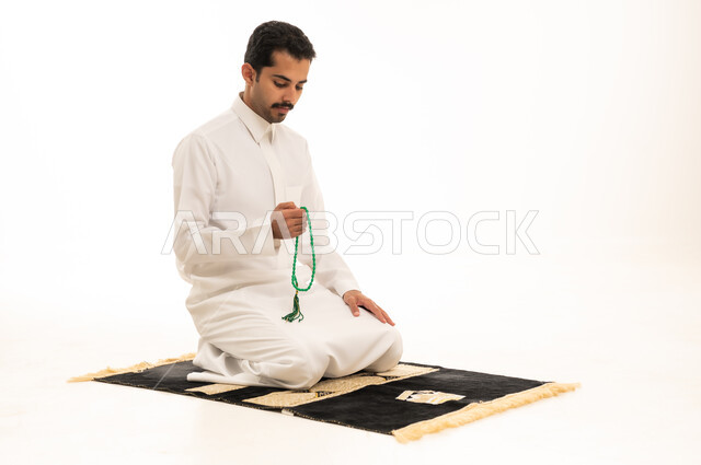 Saudi Man in White Thobe Holding Prayer Beads