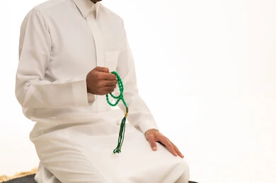 Saudi Man with Green Prayer Beads in White Thobe