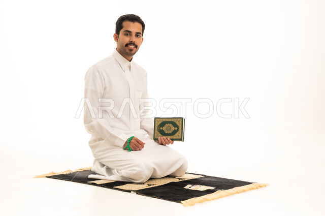 Saudi Man with Holy Quran on Prayer Mat