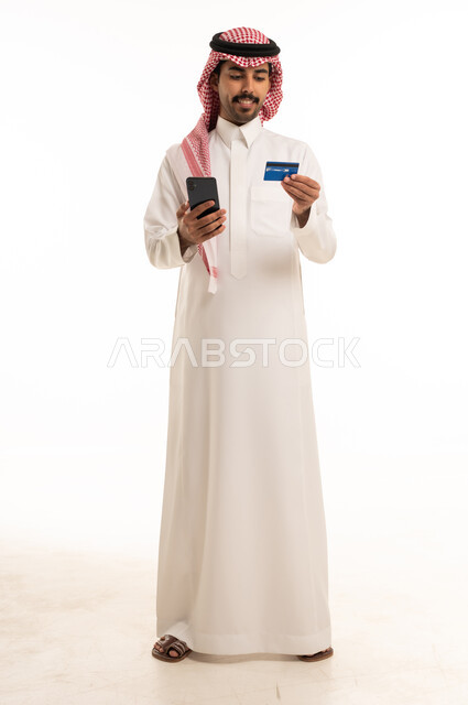 Saudi Man Using Credit Card and Smartphone Studio