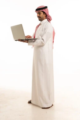 Saudi Man Using Laptop on White Background