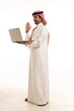 Saudi Man Holding Laptop and Waving on White Background