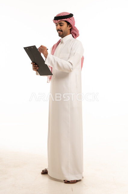 Saudi Man Writing on Clipboard in Studio