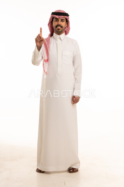 Saudi Man in Traditional Thobe Pointing Upwards