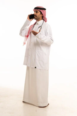 Saudi Male Doctor Talking on Smartphone Full Body