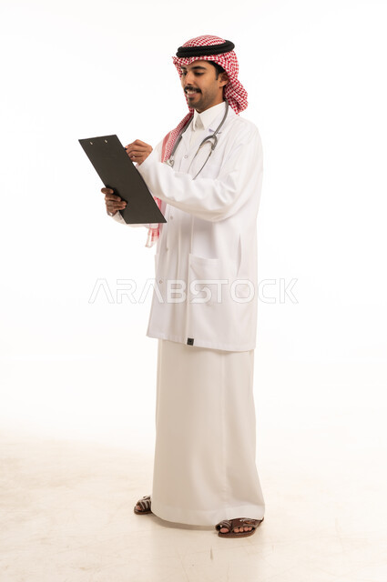 Saudi Male Doctor Writing on Clipboard White Background