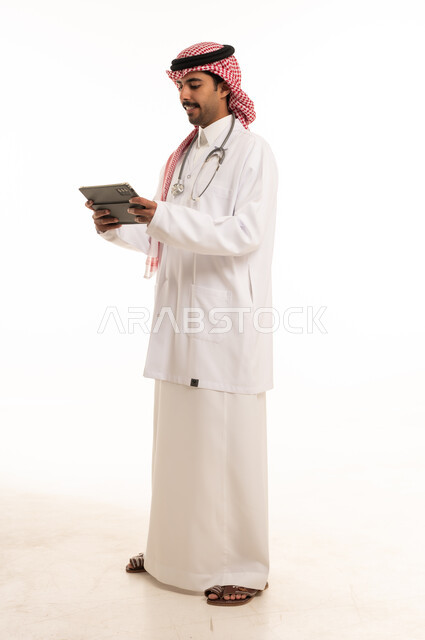 Saudi Male Doctor Using Digital Tablet on White Background