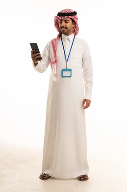 Saudi Man in Thobe Using Smartphone on White Background