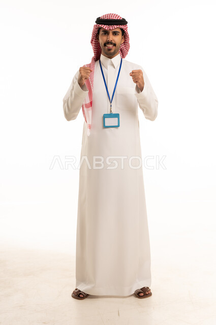 Saudi Man in Traditional Thobe with Success Gesture
