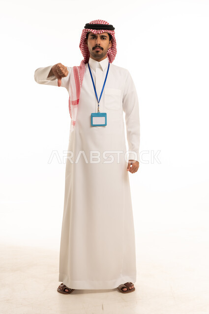 Saudi Man in Thobe Making Thumbs Down Gesture