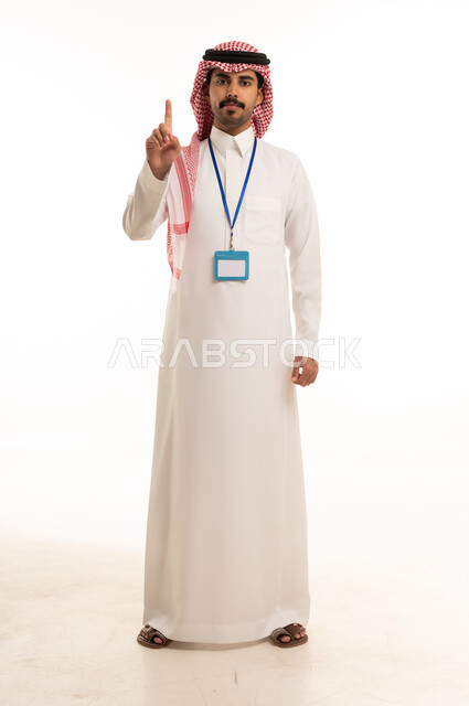Saudi Man in Traditional Thobe Pointing Upward