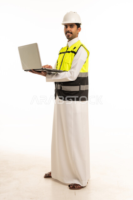 Saudi Engineer in Safety Vest Holding Laptop