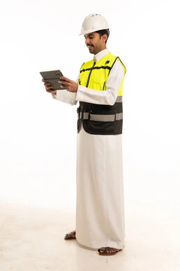 Saudi Engineer in Safety Vest Using Tablet on White