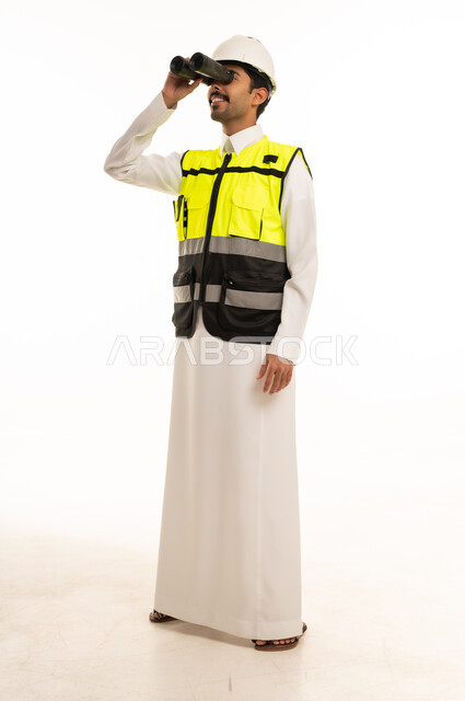 Saudi Engineer in Thobe Using Binoculars on White