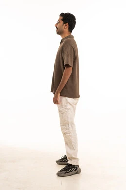 Saudi Man Standing in Profile Studio White Background