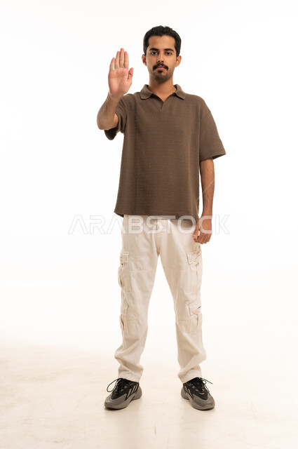 Saudi Man Making Stop Hand Gesture on White Background