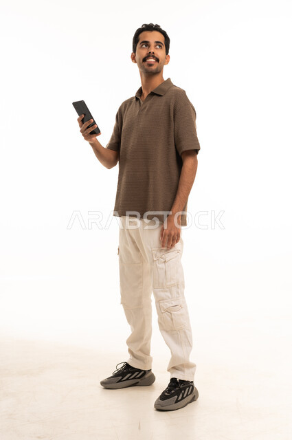 Saudi Man Holding Smartphone on White Background