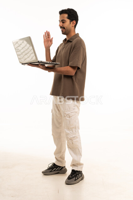Saudi Man Holding Laptop Waving on White Background