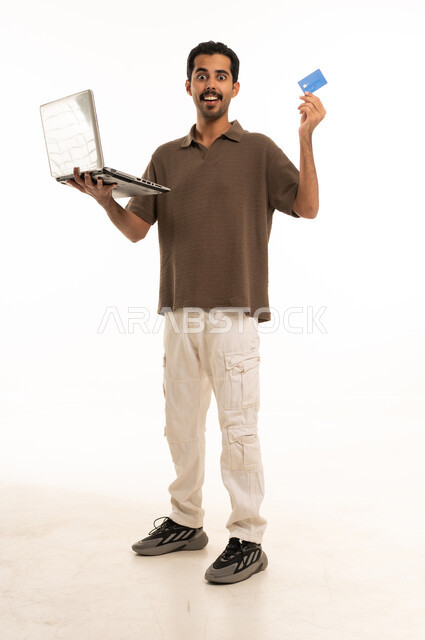 Saudi Man Holding Laptop and Credit Card White Background