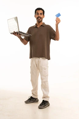 Saudi Man Holding Laptop and Credit Card White Background