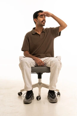 Saudi Man on Office Chair Looking into Distance