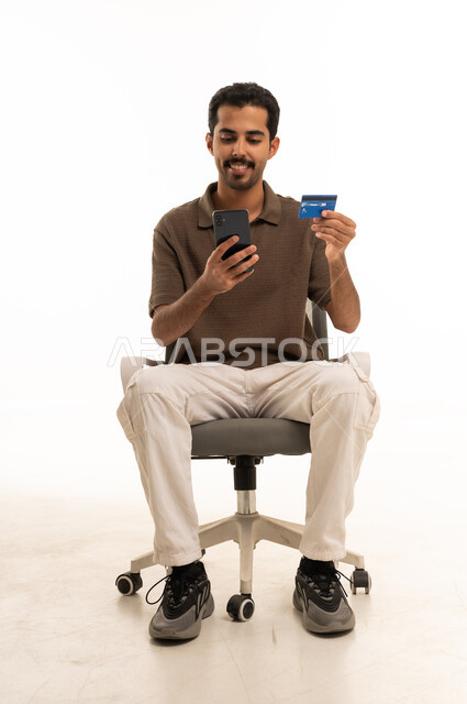 Arab Man Using Smartphone and Credit Card on White Background