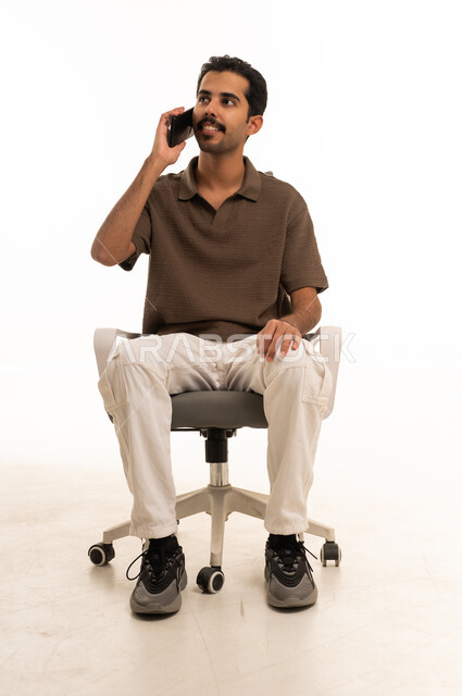 Saudi Man Talking on Smartphone Sitting in Office Chair