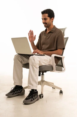Arab Man Waving at Laptop During Video Call