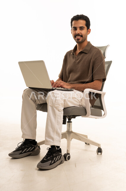 Saudi Man Using Laptop on Office Chair Studio