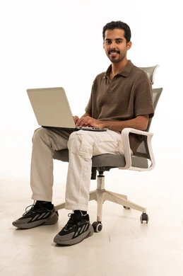 Saudi Man Using Laptop on Office Chair Studio