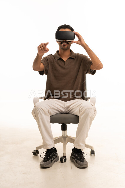 Saudi Man Using Virtual Reality Headset on White Background