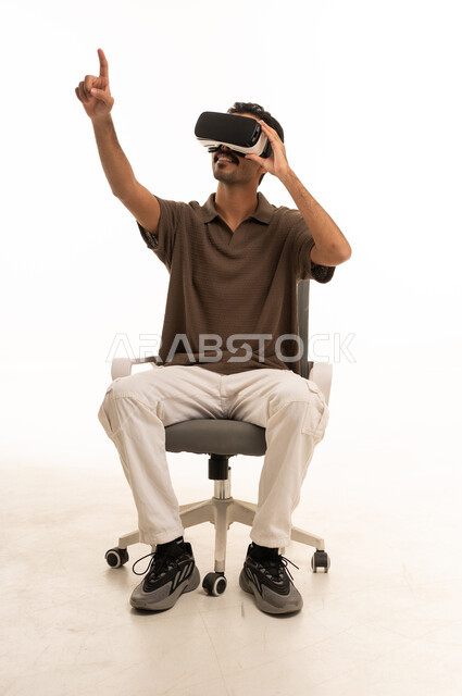 Arab Man Using VR Headset in Studio Setting