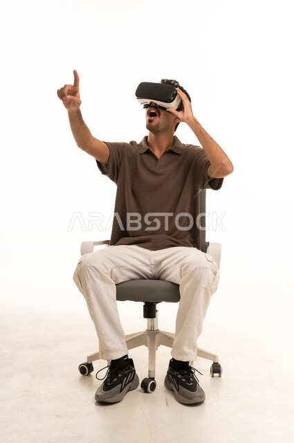 Saudi Man Wearing VR Headset Pointing in Studio