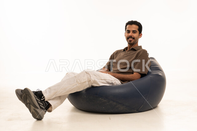 Saudi Man Relaxing in Bean Bag on White Background