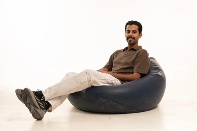 Saudi Man Relaxing in Bean Bag on White Background