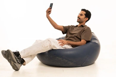 Saudi Man Studio Portrait with Smartphone on Beanbag