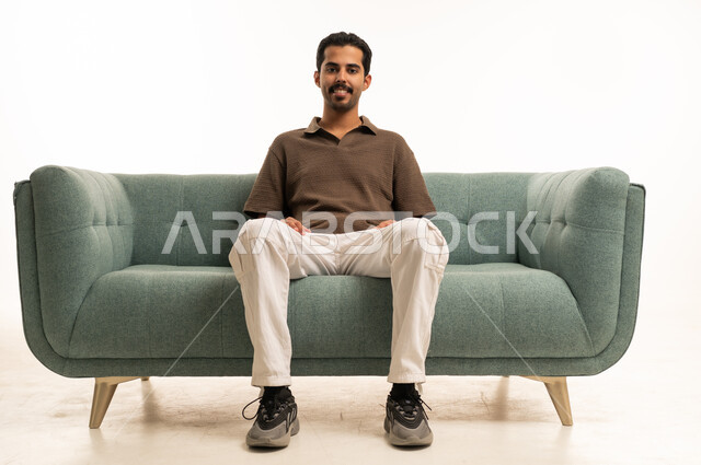 Saudi Man Sitting on Sofa in Studio Background