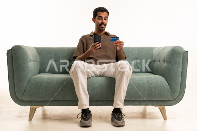 Arab Man Using Credit Card and Smartphone for Shopping