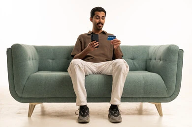 Arab Man Using Credit Card and Smartphone for Shopping