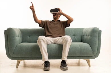 Saudi Man Using VR Headset on Sofa in Studio