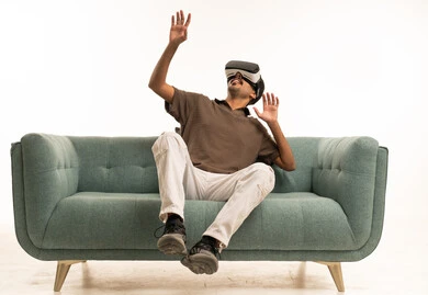 Saudi Man Using VR Headset on Sofa in Studio