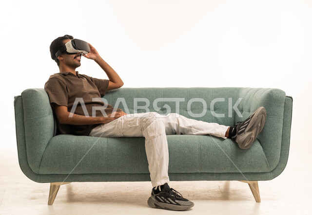 Saudi Man Using VR Headset on Sofa