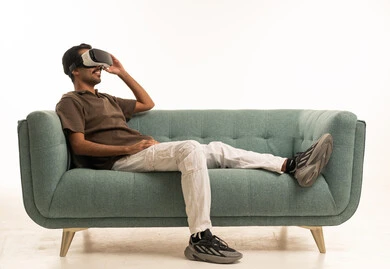 Saudi Man Using VR Headset on Sofa